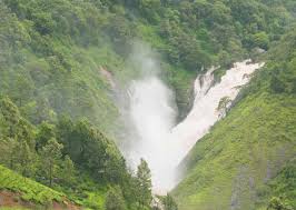 Nature lovers enjoying Attukad Waterfalls in Kerala's Western Ghats