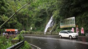 Misty roadside waterfall in Idukki Kerala